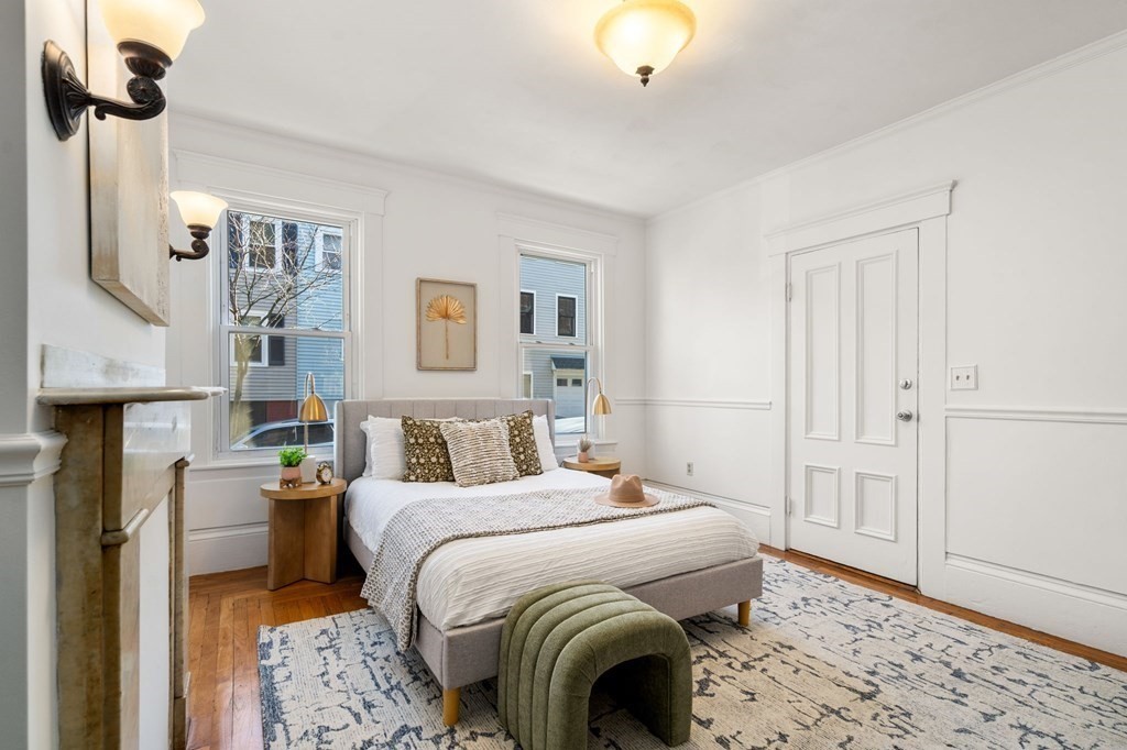 110 Elm Street, Unit 1 Boston, MA 02129 - Photo 5 of 17 a bedroom with a bed and a chandelier