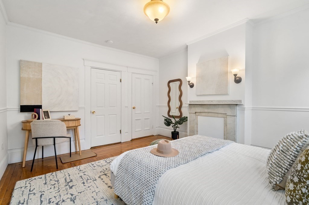 110 Elm Street, Unit 1 Boston, MA 02129 - Photo 6 of 17 a bedroom with a bed and a chandelier