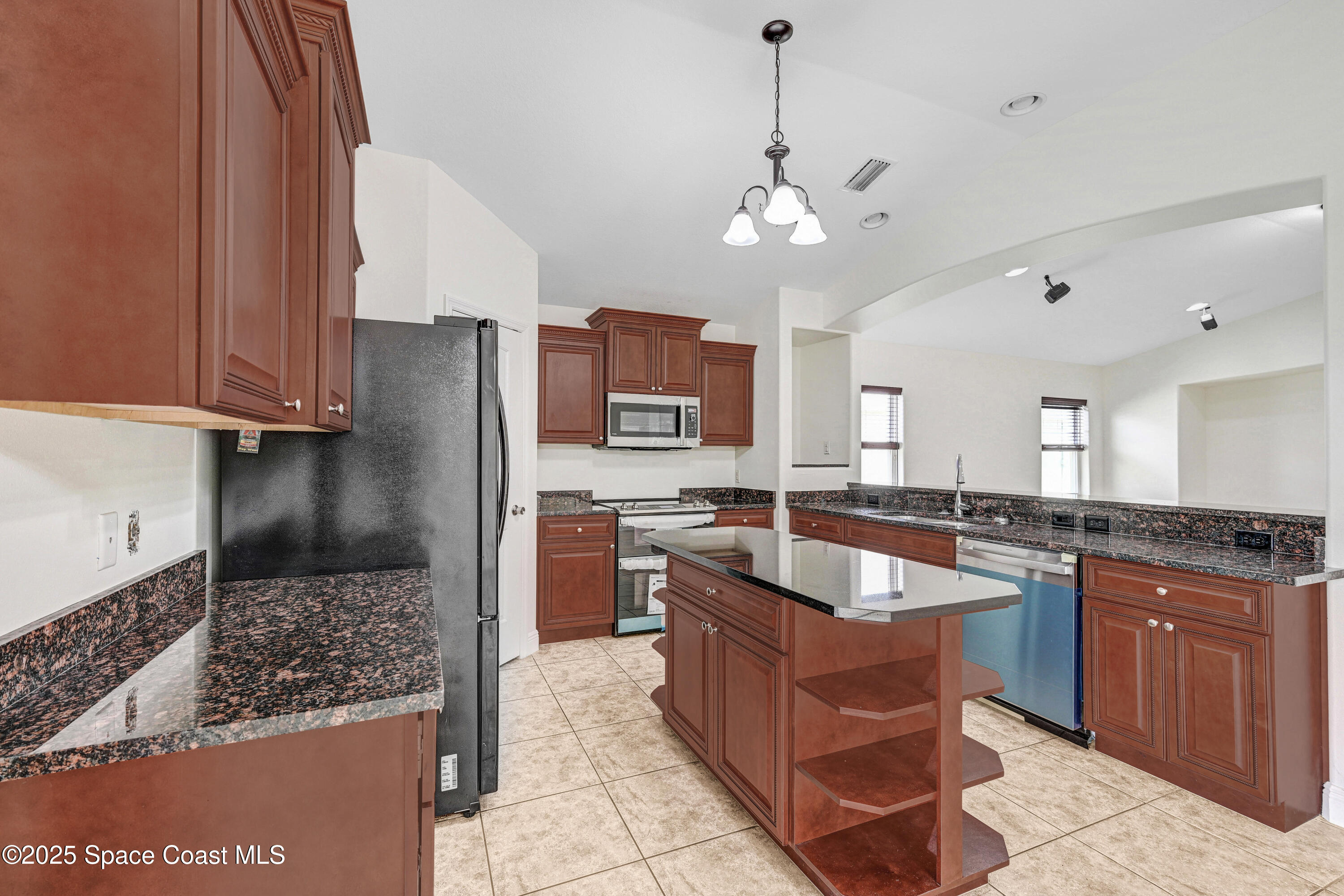 4031 Brantley Circle Rockledge, FL 32955 - Photo 11 of 41 a kitchen with stainless steel appliances granite countertop a sink a stove and a refrigerator