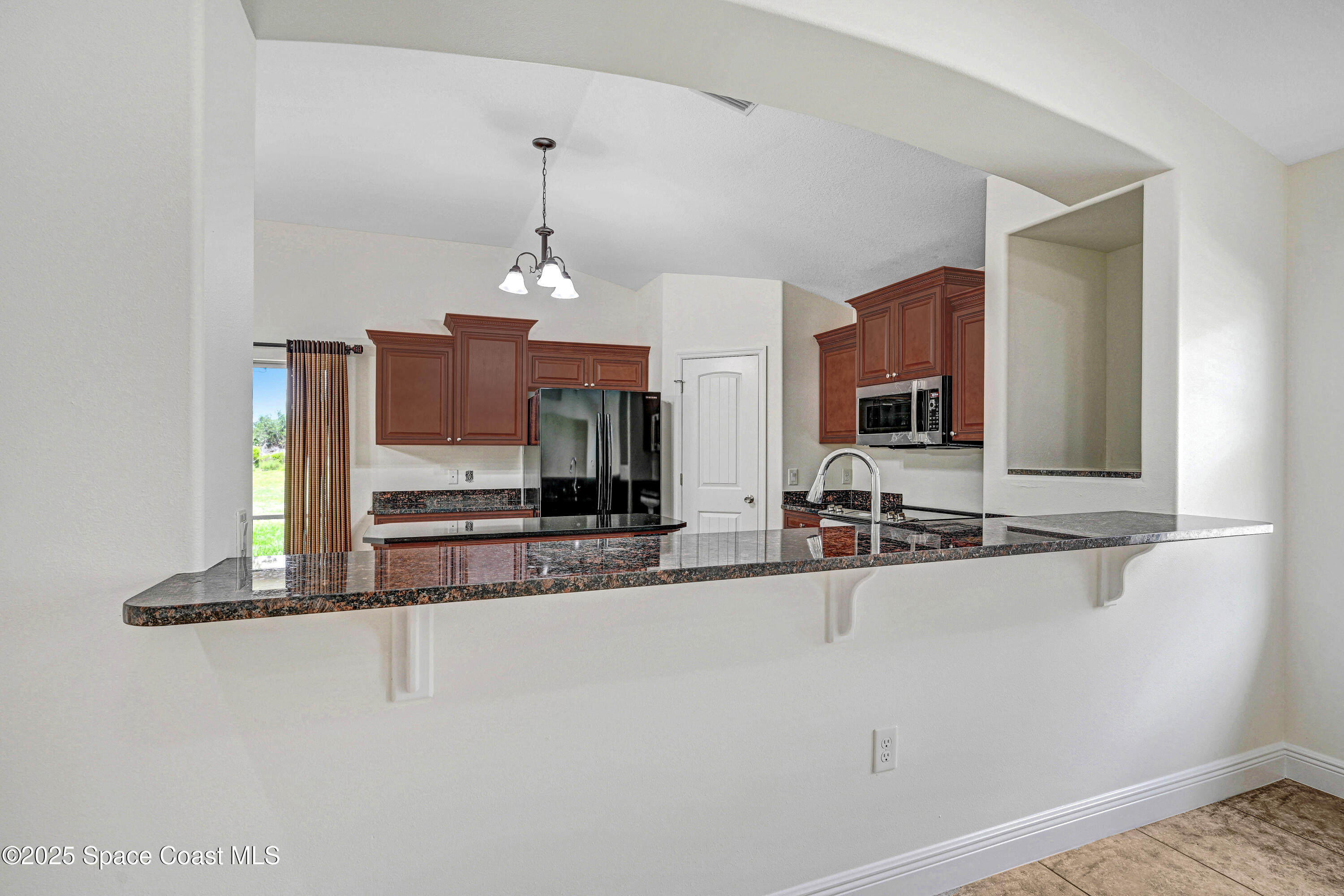 4031 Brantley Circle Rockledge, FL 32955 - Photo 14 of 41 a view of a kitchen with kitchen island granite countertop refrigerator and sink