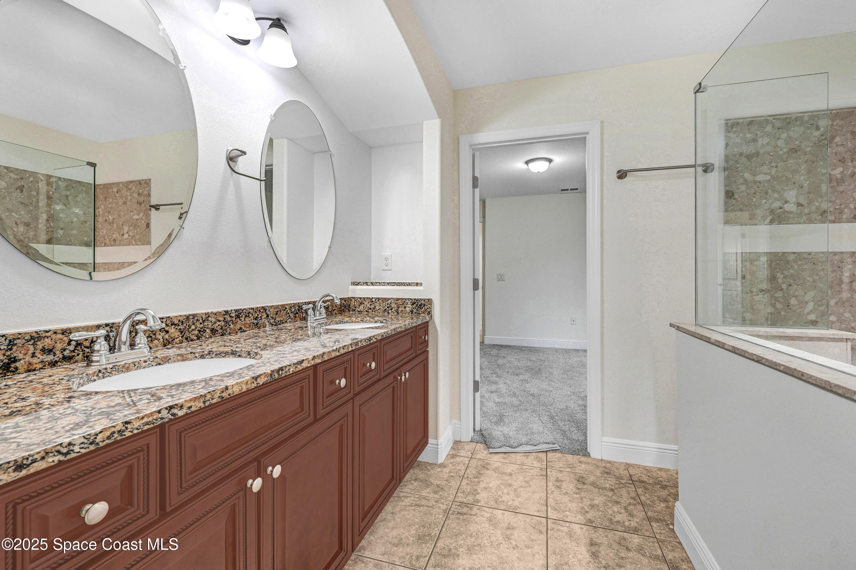 4031 Brantley Circle Rockledge, FL 32955 - Photo 15 of 41 a bathroom with a granite countertop double vanity sink and a mirror