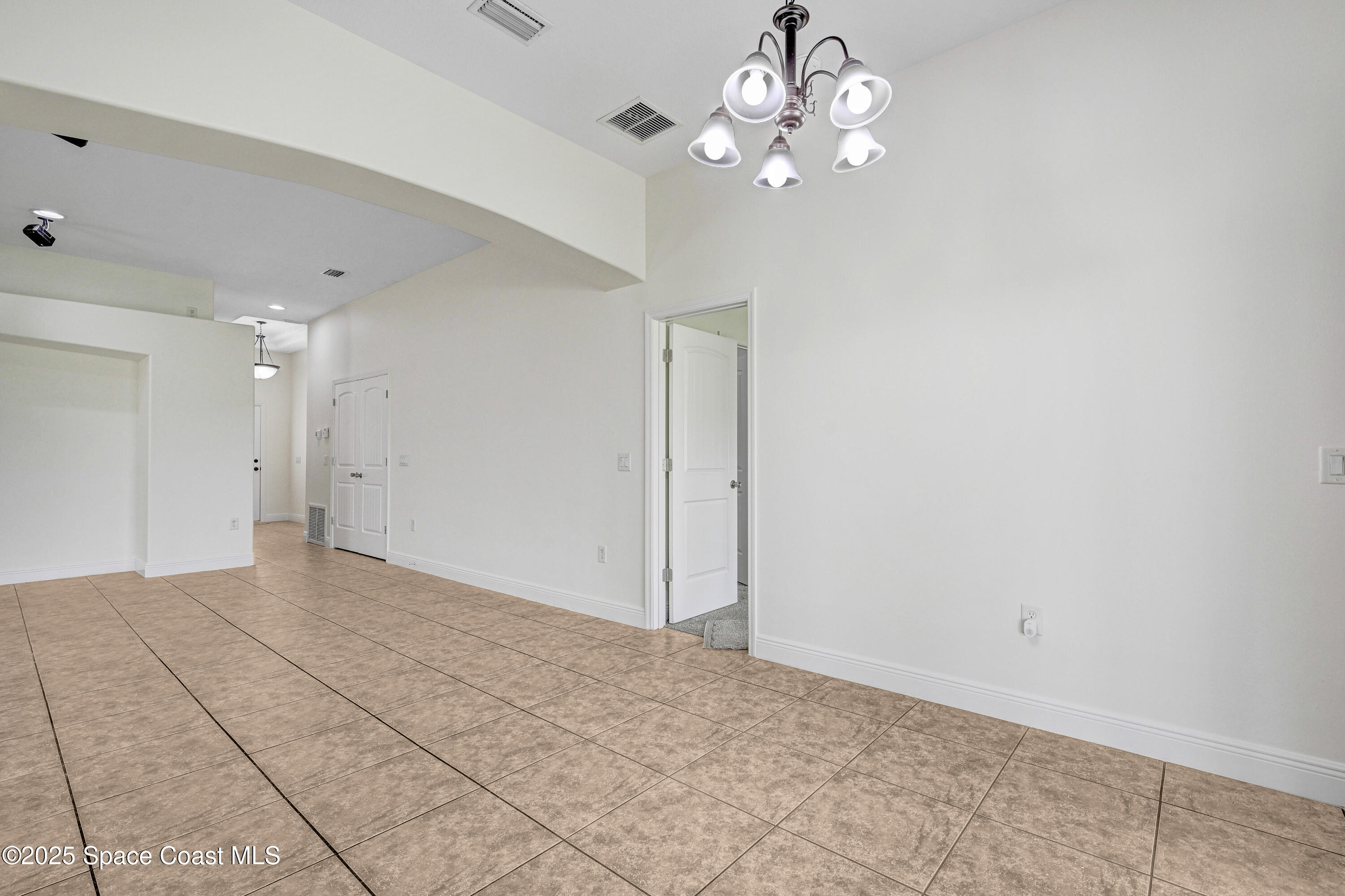 4031 Brantley Circle Rockledge, FL 32955 - Photo 34 of 41 a view of an empty room with a chandelier fan