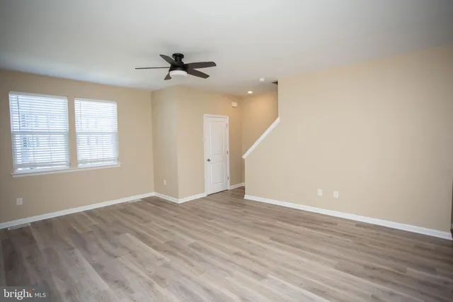 a kitchen with a sink cabinets and wooden floor