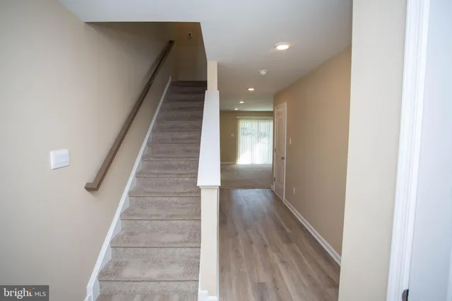 a view of entryway and hall with wooden floor