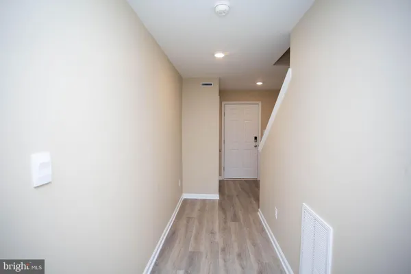 a view of hallway with wooden floor