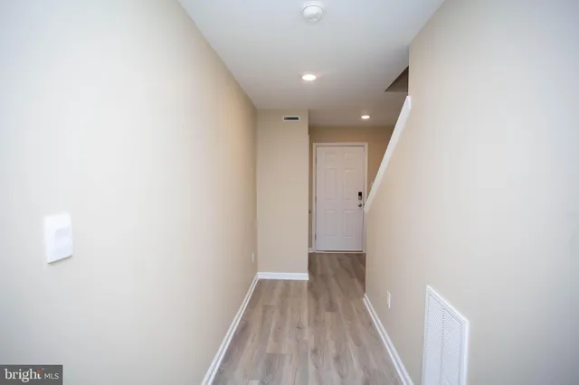 a view of hallway with wooden floor