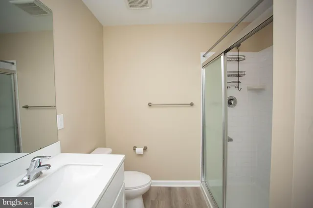 an empty room with a ceiling fan and a window