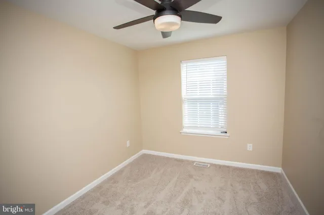 a view of a house with a wooden deck