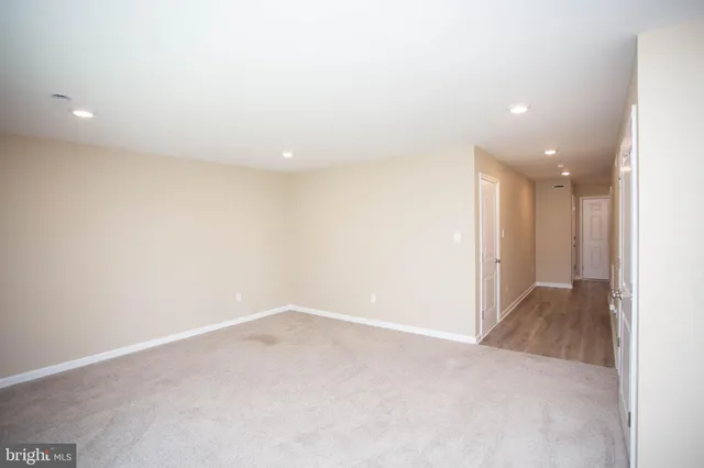 a view of a kitchen with a sink and dishwasher a refrigerator with wooden floor