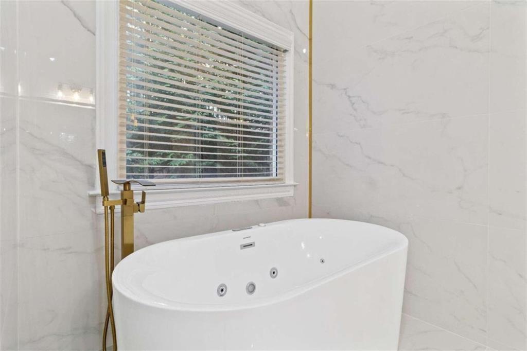 1711 Summit Glen Lane Northeast Atlanta, GA 30329 - Photo 20 of 42 a white bath tub sitting in a bathroom