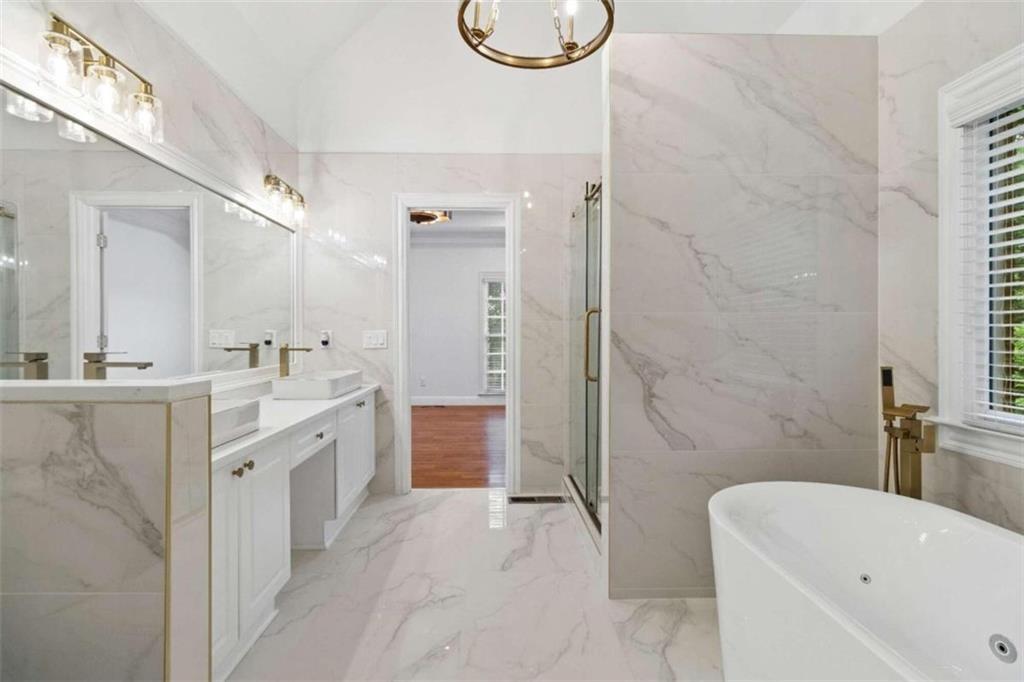 1711 Summit Glen Lane Northeast Atlanta, GA 30329 - Photo 22 of 42 a bathroom with a tub sink and mirror