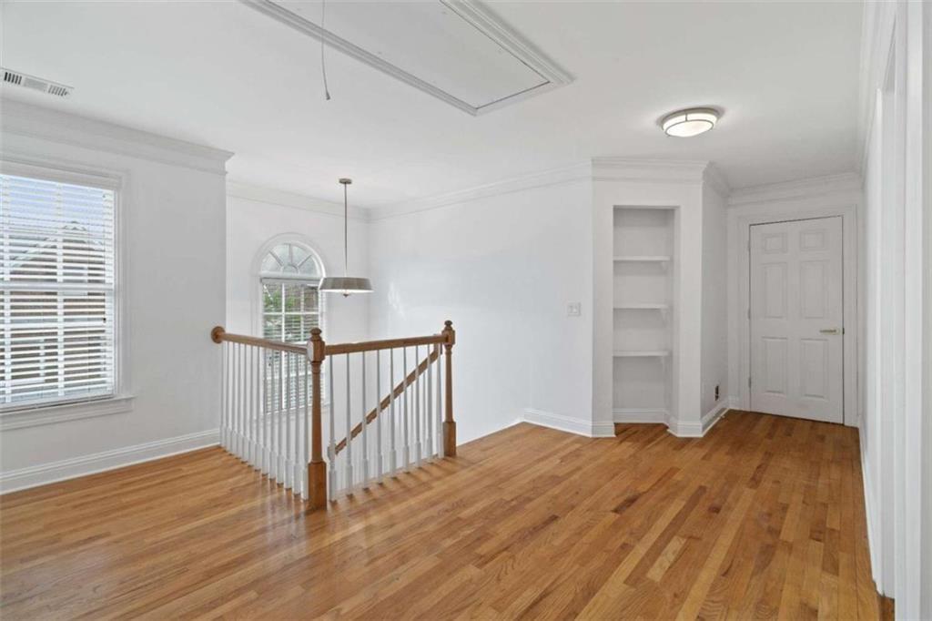 1711 Summit Glen Lane Northeast Atlanta, GA 30329 - Photo 24 of 42 a view of a room with wooden floor and white walls