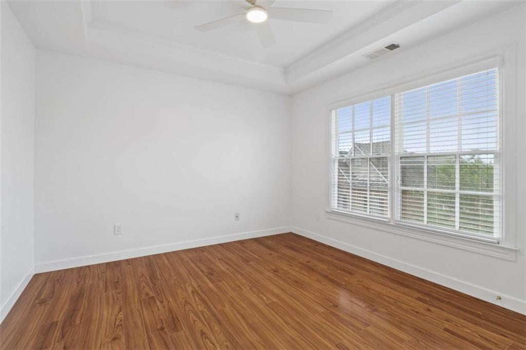 1711 Summit Glen Lane Northeast Atlanta, GA 30329 - Photo 25 of 42 an empty room with wooden floor and windows
