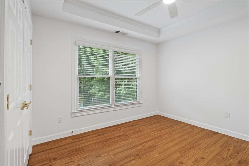 1711 Summit Glen Lane Northeast Atlanta, GA 30329 - Photo 27 of 42 a view of an empty room with wooden floor and a window
