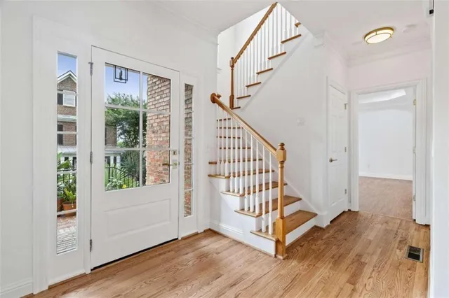a view of entryway with stairs and wooden floor