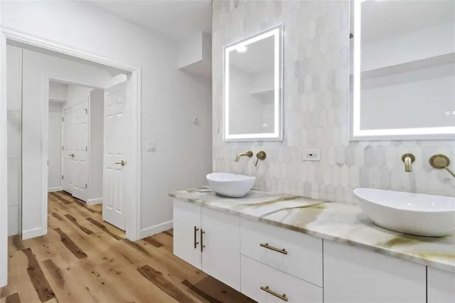 a bathroom with a granite countertop sink and a mirror