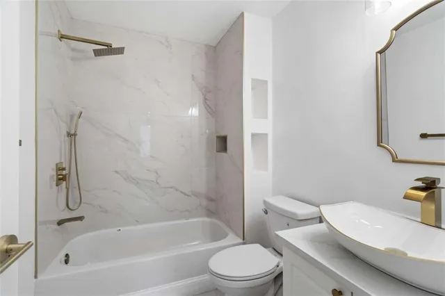 a bathroom with a toilet and a bath tub