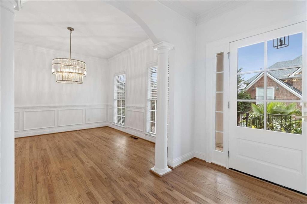 1711 Summit Glen Lane Northeast Atlanta, GA 30329 - Photo 4 of 42 a view of an empty room with wooden floor and a window