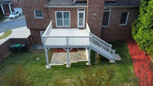 a view of a house with a yard deck and sitting area