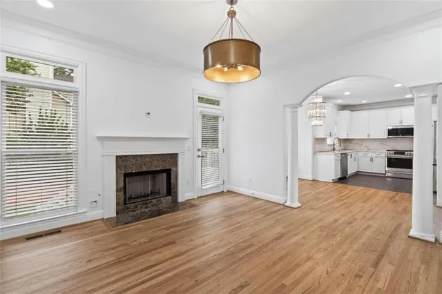 a view of kitchen and hall with wooden floor
