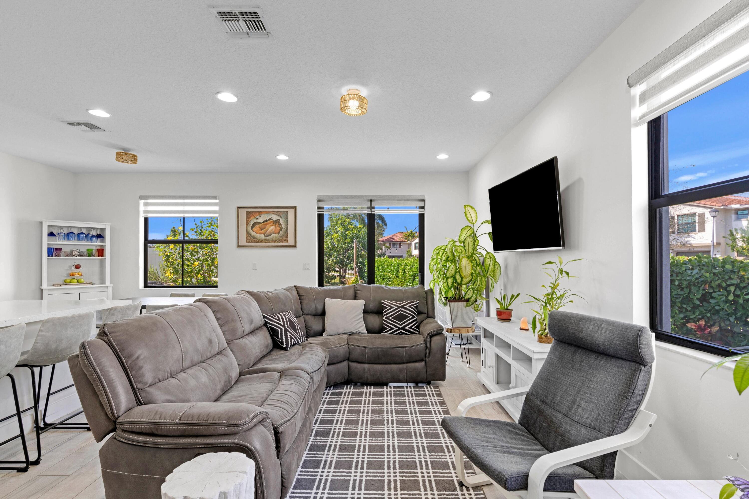 4021 Sycamore Cove Riviera Beach, FL 33410 - Photo 14 of 37 a living room with furniture and a flat screen tv