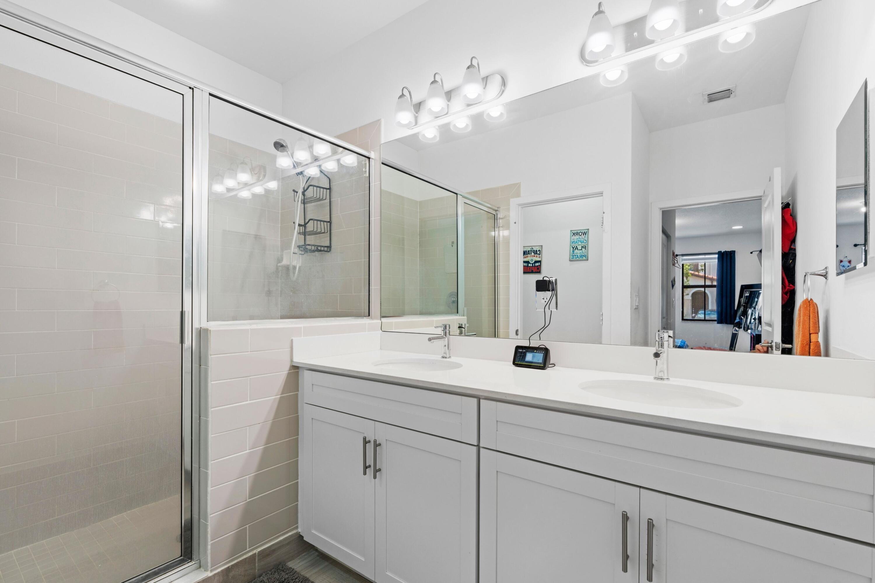 4021 Sycamore Cove Riviera Beach, FL 33410 - Photo 18 of 37 a bathroom with a double vanity sink mirror and double