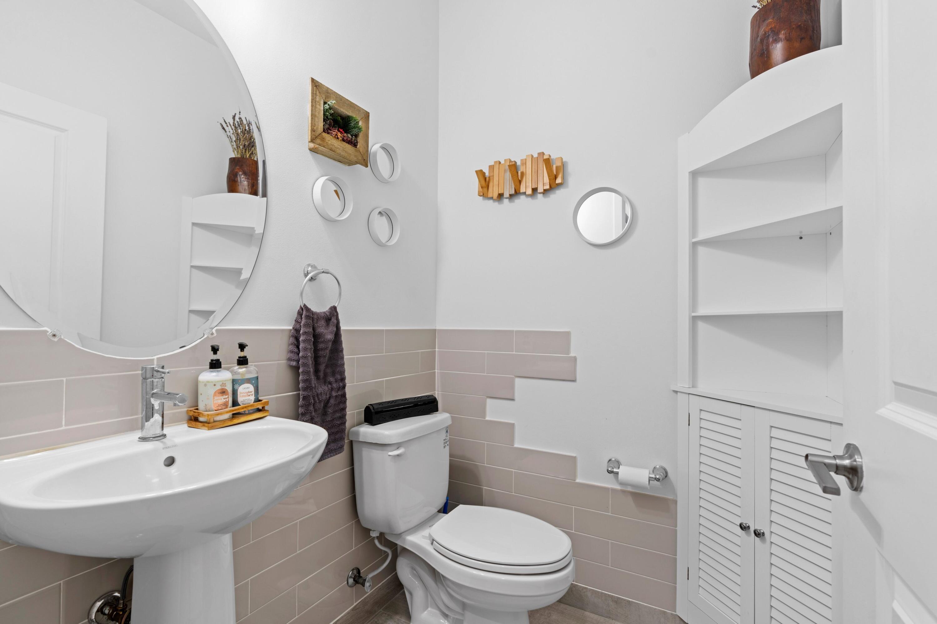 4021 Sycamore Cove Riviera Beach, FL 33410 - Photo 19 of 37 a bathroom with a sink a toilet and a mirror