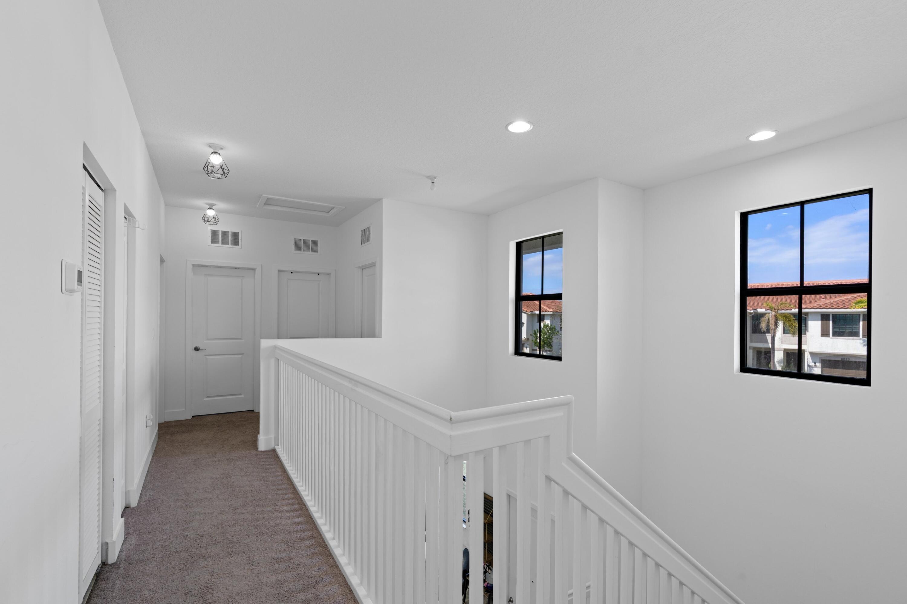 4021 Sycamore Cove Riviera Beach, FL 33410 - Photo 22 of 37 a view of a hallway with an entryway
