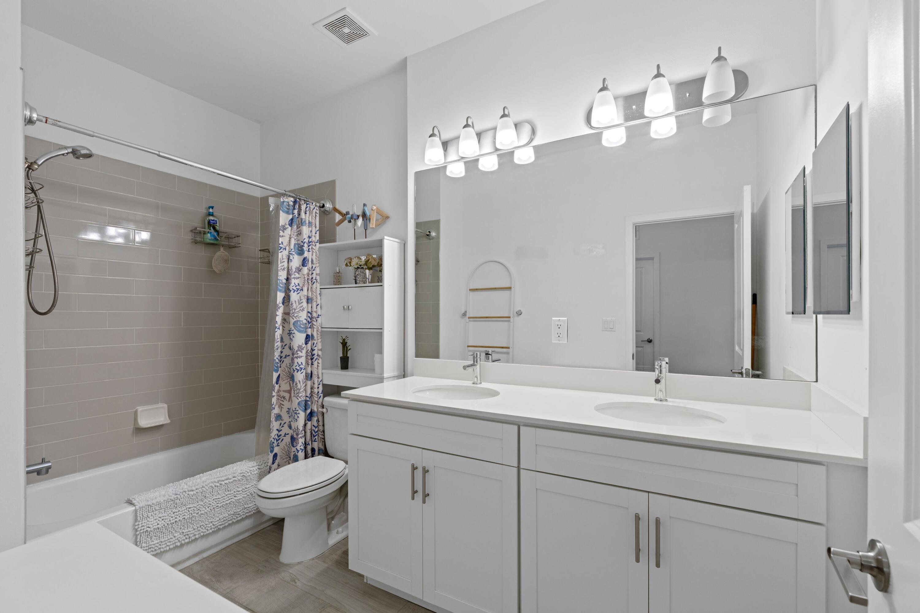 4021 Sycamore Cove Riviera Beach, FL 33410 - Photo 23 of 37 a bathroom with a sink a toilet and shower
