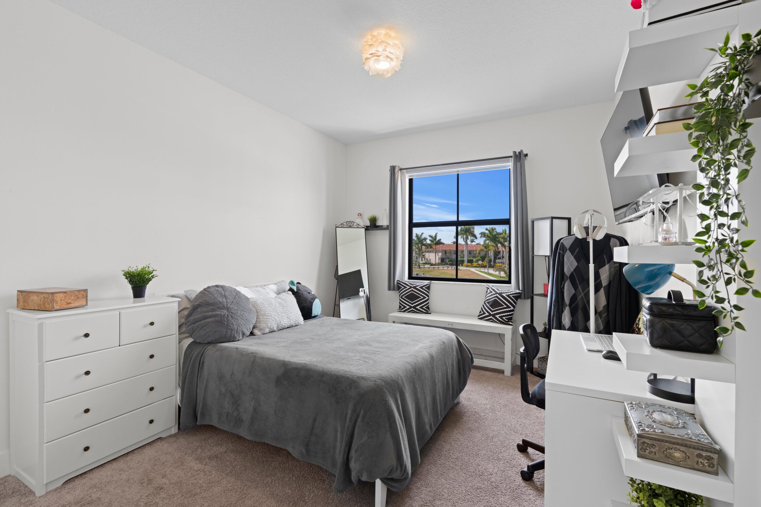 4021 Sycamore Cove Riviera Beach, FL 33410 - Photo 24 of 37 a bedroom with a bed a couch and dresser