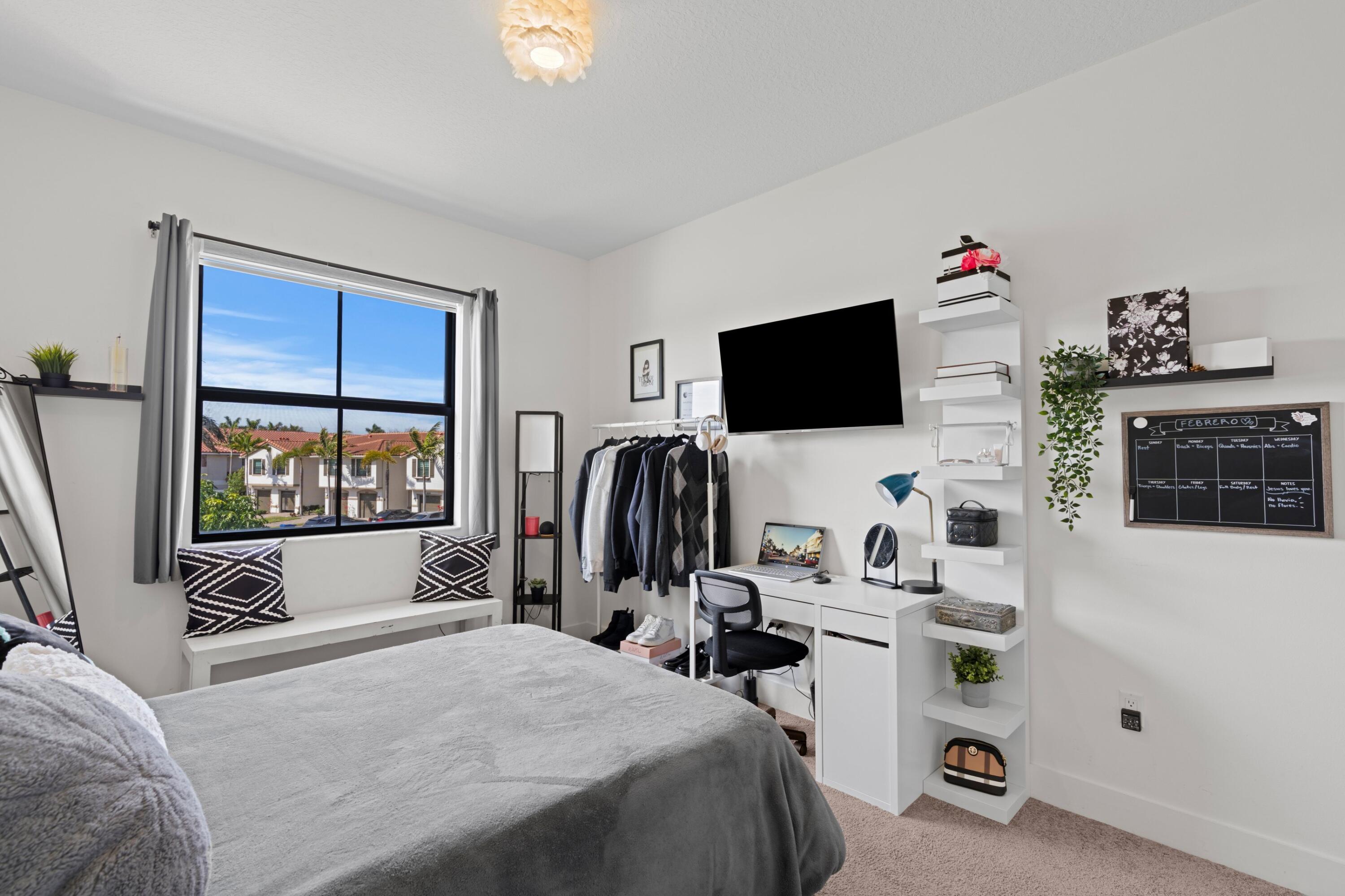 4021 Sycamore Cove Riviera Beach, FL 33410 - Photo 25 of 37 a bedroom with a bed and a flat screen tv