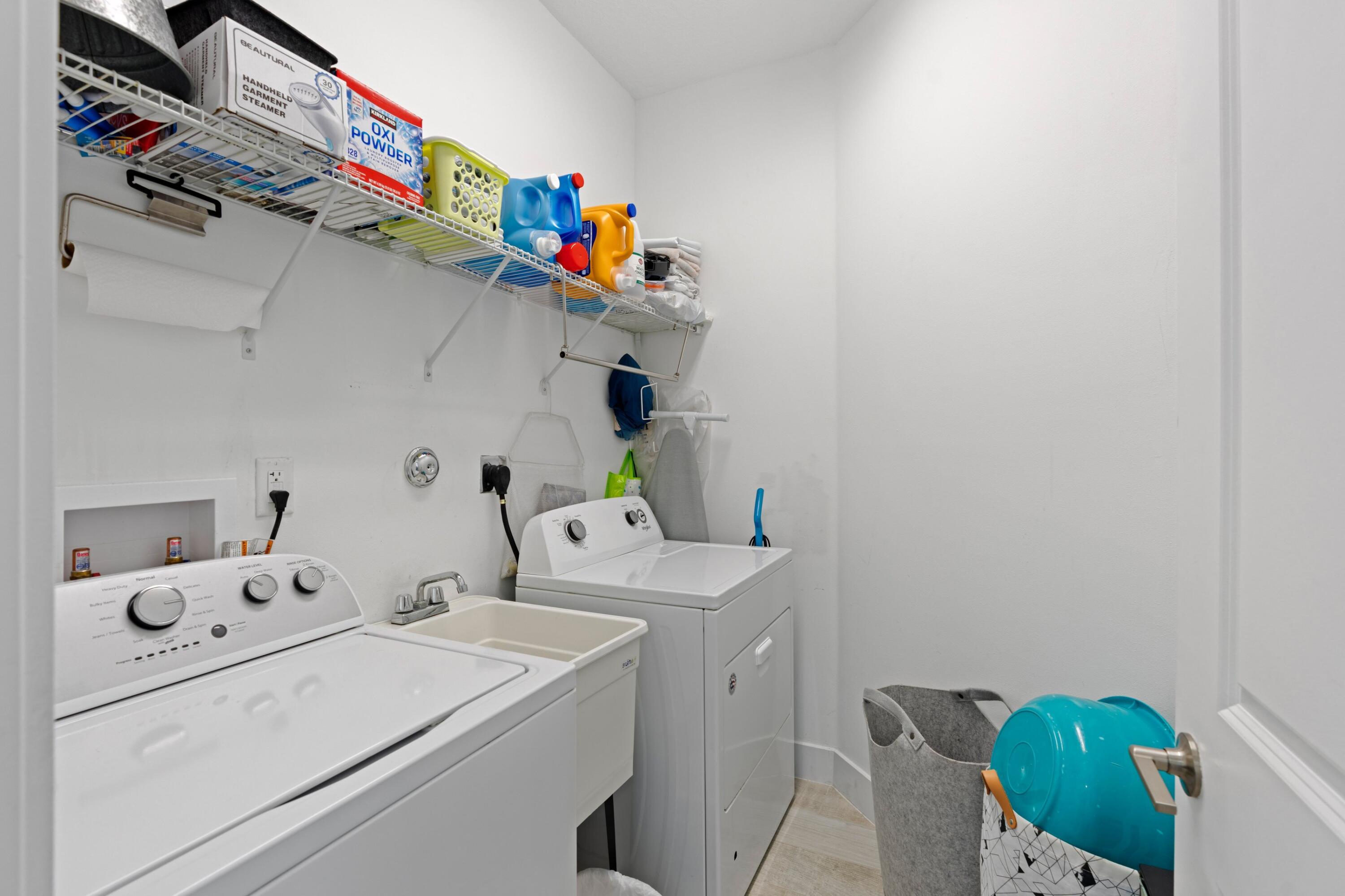 4021 Sycamore Cove Riviera Beach, FL 33410 - Photo 27 of 37 a utility room with dryer and washer