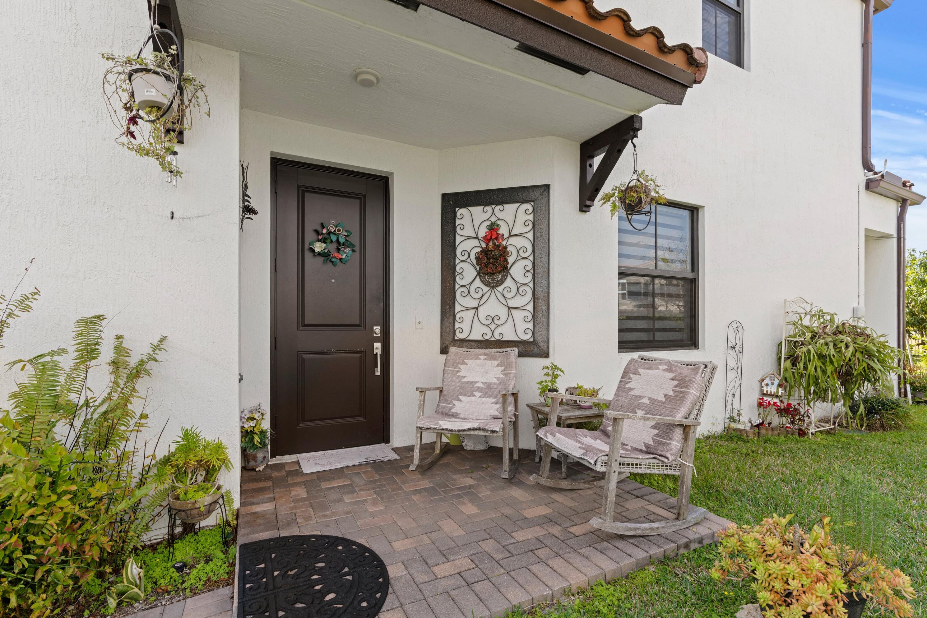 4021 Sycamore Cove Riviera Beach, FL 33410 - Photo 4 of 37 a backyard of a house with outdoor seating