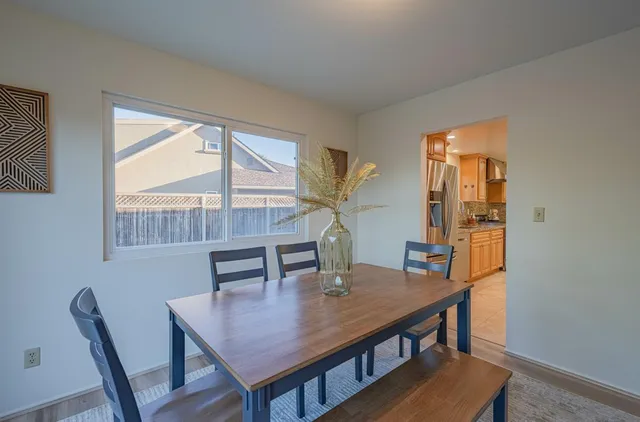 a view of a dining room with furniture and window