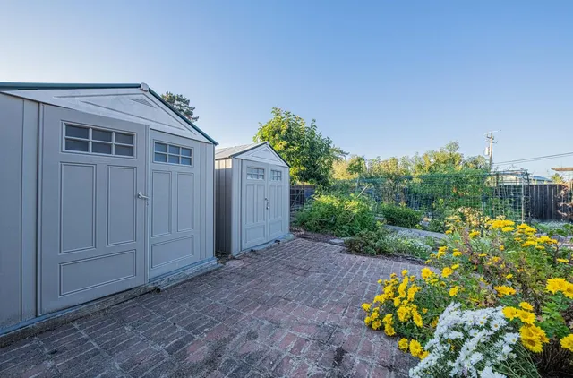 a view of a house with a lot of flower plants