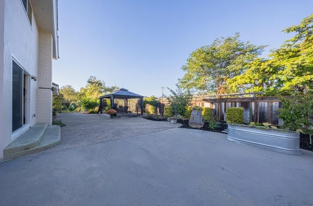 a view of a house with a yard and a garage