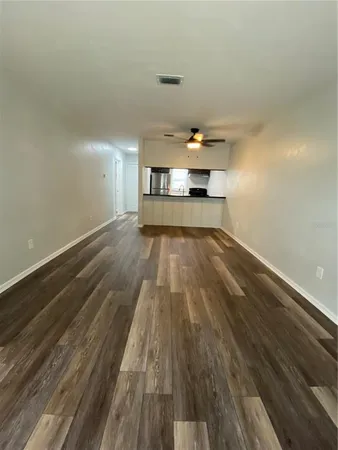 a view of a room with wooden floor