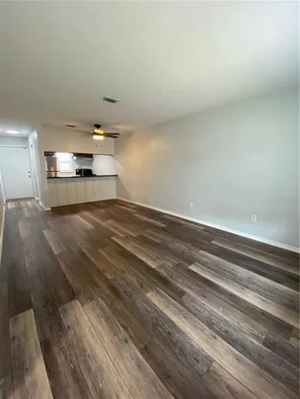a view of kitchen and empty room