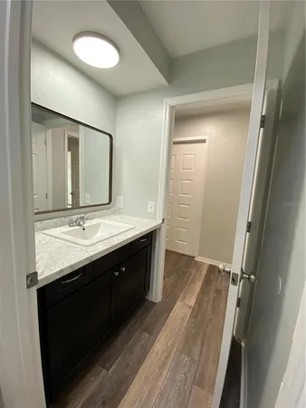 a bathroom with a double vanity sink and mirror