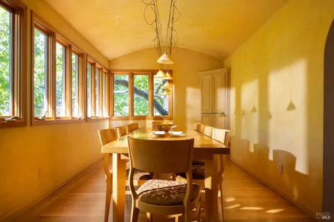 a dining room with furniture and window