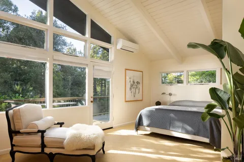 a living room with furniture and a floor to ceiling window