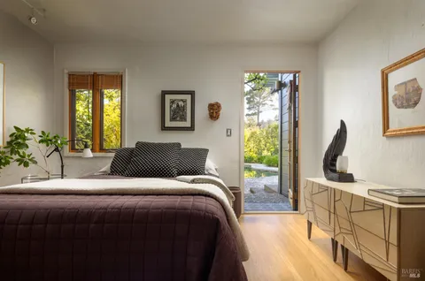 a bedroom with a bed and glass door
