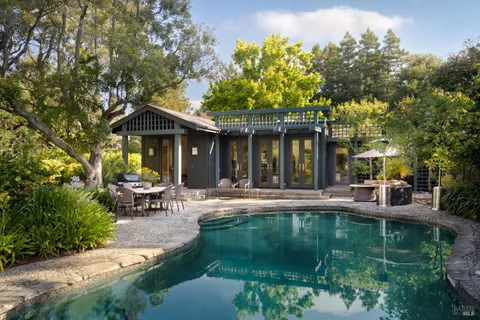 a view of a house with sitting area and garden