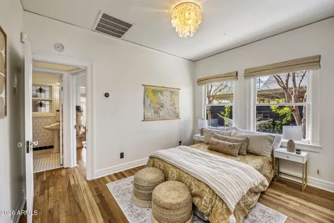 a bedroom with a bed and a large window with outer view