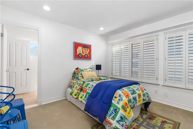 a bedroom with bed and a window