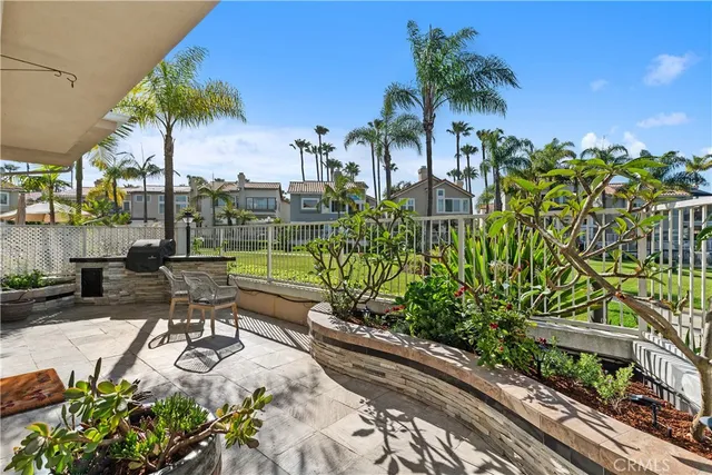 a view of a chair and tables in the patio in front of a house