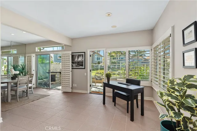 a living room with furniture and a floor to ceiling window