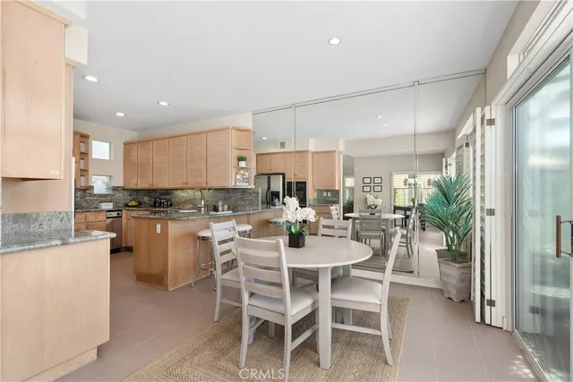 a dining room with a table chairs and a kitchen view