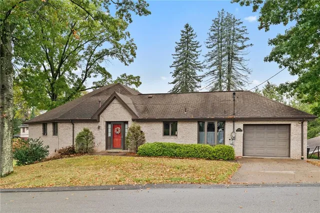 a front view of a house with a garden and yard