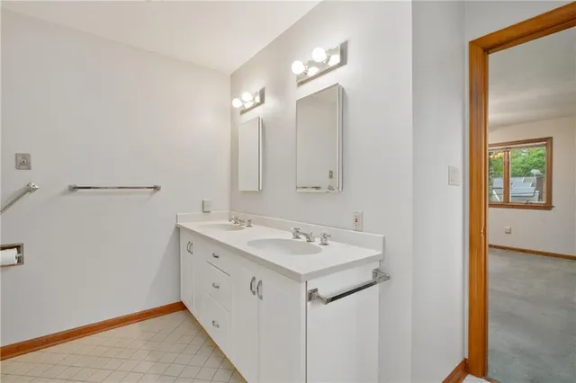 a view of a bathroom with a sink and mirror
